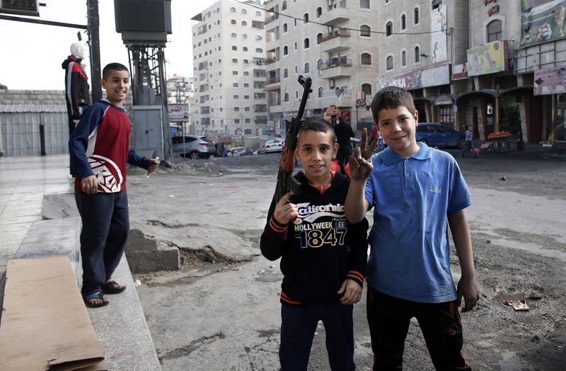 Palestinian boys toy gun