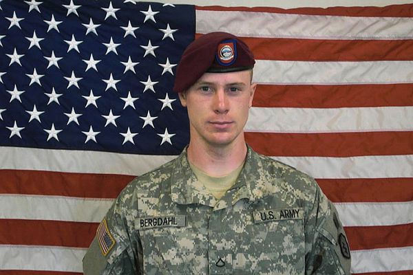 Bergdahl poses in front of an American flag.